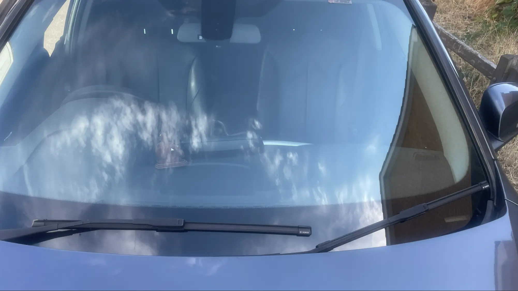 Windscreen bonded to the vehicle body using automotive adhesive